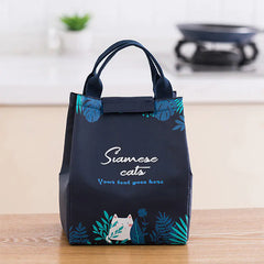 Navy blue bag with cat design and 'Siamese cats' text on a wooden surface.