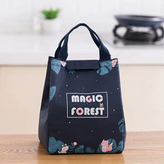 Black tote bag with 'Magic Forest' design on a wooden surface